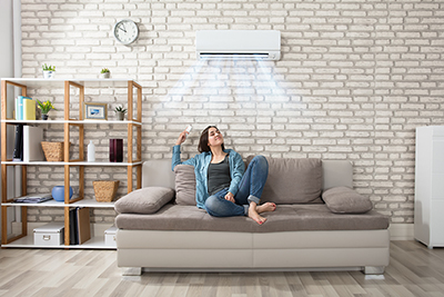 Happy Young Woman Holding Remote Control Relaxing