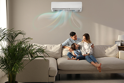 appy family resting under air conditioner on beige wall at home