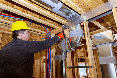 Workers making final air duct conditioning HVAC system ventilation pipes stands for heating